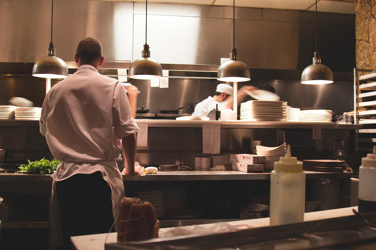 Chefs and cooks work in a commercial kitchen